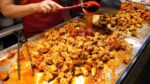 Um restaurante de mercado que oferece uma grande quantidade a um preço baixo / Frango agridoce / comida de rua coreana