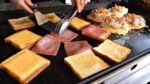 Mestre do brinde de rua!  Torrada de ovo com queijo e presunto/torrada de ovo com queijo e presunto coreano/comida de rua coreana